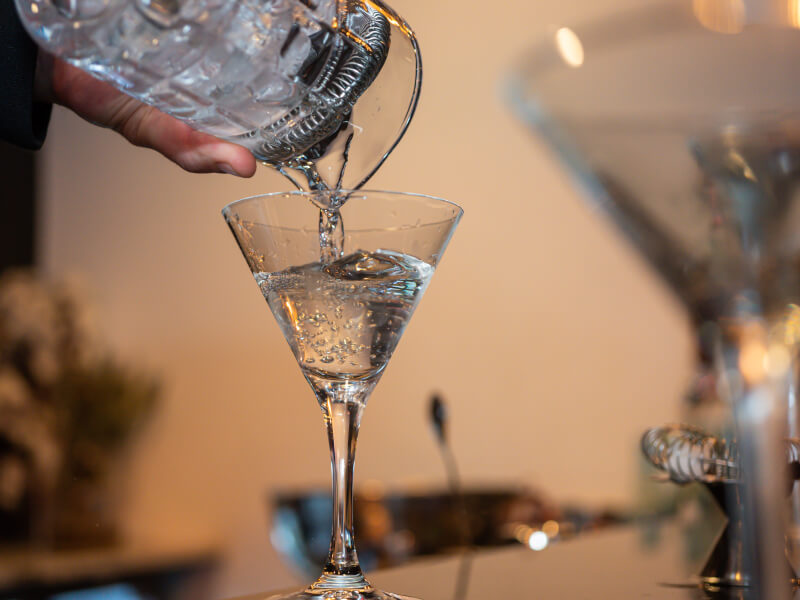 hand pouring cocktail